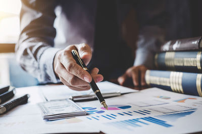 Midsection of man working on table