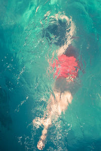 High angle view of woman swimming in sea