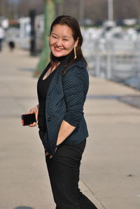 Portrait of smiling young woman using mobile phone