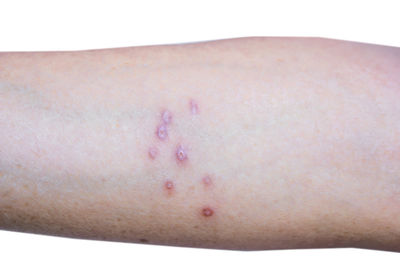 Close-up of woman's hand against white background