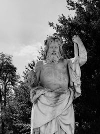 Low angle view of statue against trees