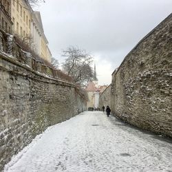 Snow covered city against sky