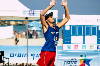 Full length of young woman standing against the wall
