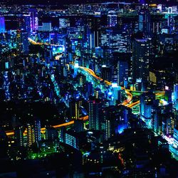 Illuminated modern buildings in city at night