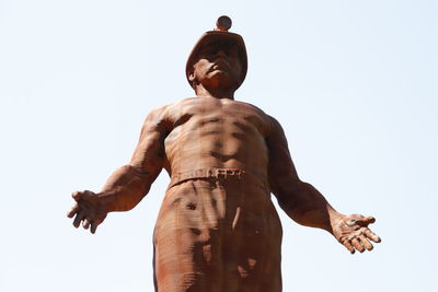 Low angle view of shirtless man against sky