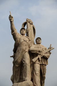 Low angle view of statue against sky