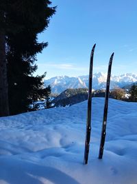 Scenic view of snow covered mountains against blue sky