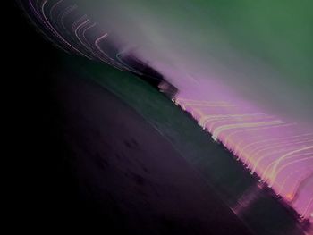 Abstract image of illuminated lights against sky at night