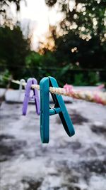 Close-up of clothespins on clothesline in park