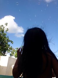 Close-up of woman against sky