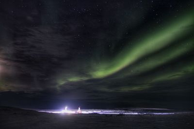 Scenic view of lake against sky at night