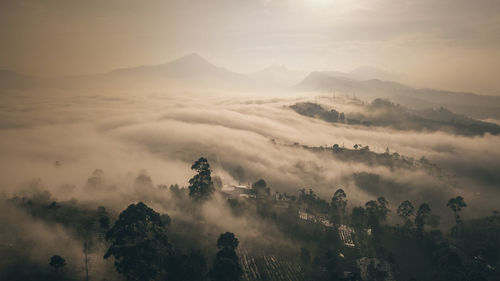 Scenic view of mountains against sky during foggy weather