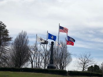 Low angle view of flag on built structure against sky