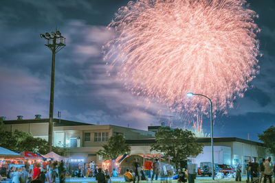 Low angle view of people on street at night