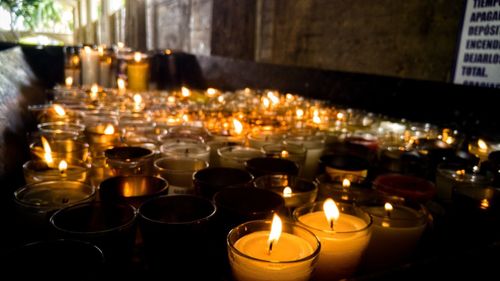 Lit tea light candles in temple