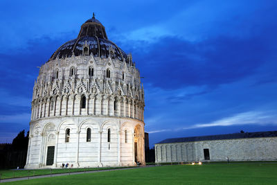 Pisa baptistery against blue sky at dusk