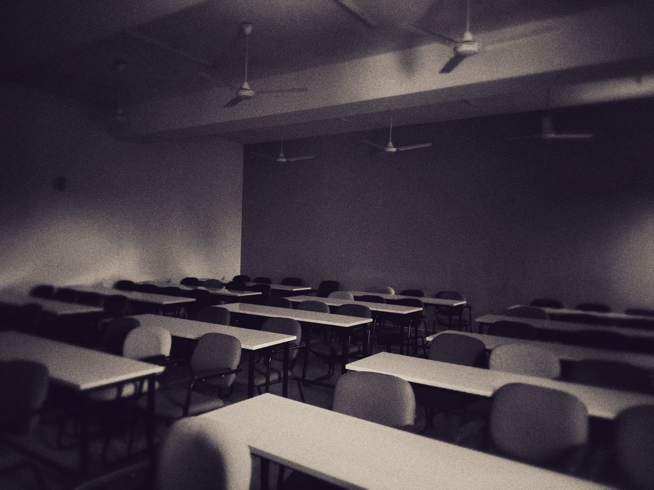 auditorium, indoors, room, black, seat, no people, light, white, education, in a row, chair, lighting, classroom, school, monochrome, absence, black and white, learning, darkness, conference hall, lecture hall, table