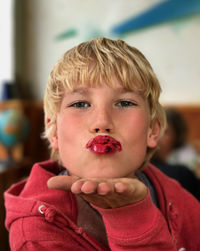 Close-up portrait of boy blowing kiss