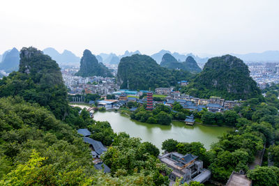 High angle view of buildings and mountains against sky