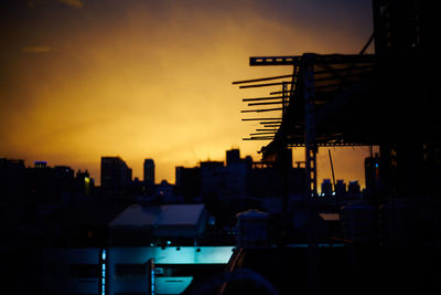 Silhouette of buildings against sky during sunset