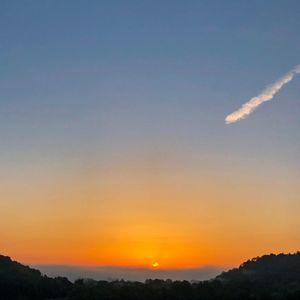 Scenic view of silhouette landscape against sky during sunset