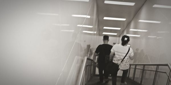 Rear view of people walking on road