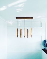 Wooden wind chime hanging on ceiling at home