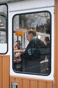 Reflection of woman on train window