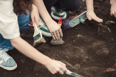 Low section of man tying shoelace