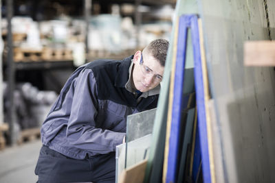 Midsection of man working in factory