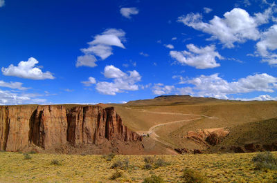 Scenic view of landscape against blue sky