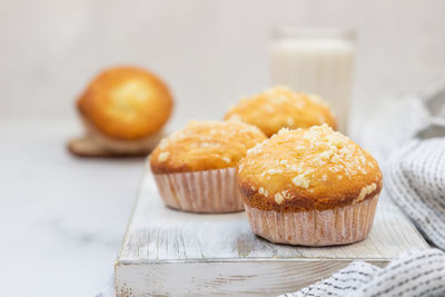 Vanilla muffins and muffins with streusel in paper cups with milk. breakfast or snack for children.