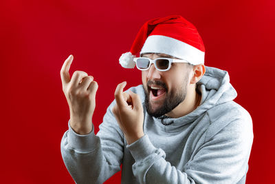 Midsection of man wearing hat against red background