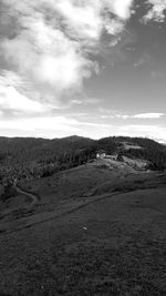 Scenic view of landscape against cloudy sky