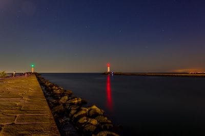 Scenic view of sea against clear sky at night