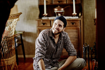 Smiling young man in checked shirt