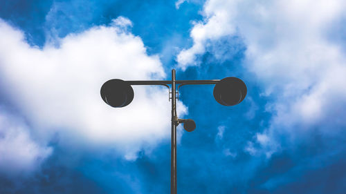 Low angle view of street light against cloudy sky