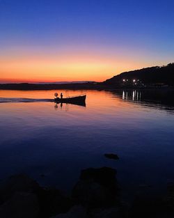 Scenic view of lake against sky at sunset