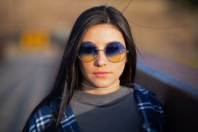 Portrait of a young woman wearing sunglasses
