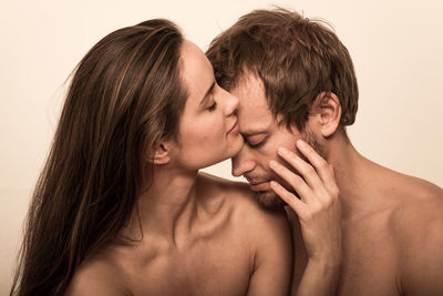 Portrait of young couple kissing