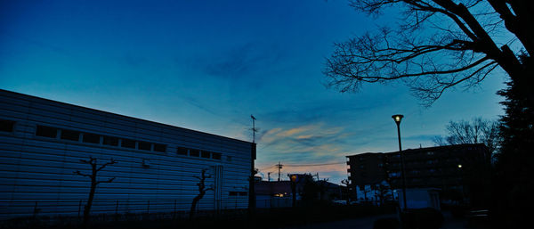 Low angle view of silhouette buildings against sky