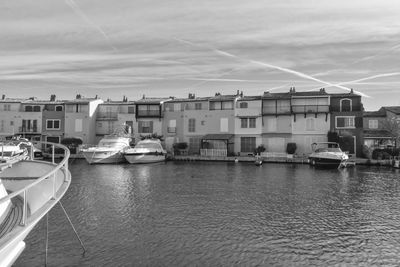 Boats moored on shore against sky