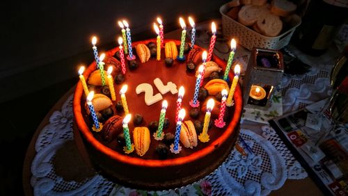High angle view of lit candles on birthday cake
