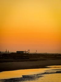 Scenic view of beach against sky during sunset