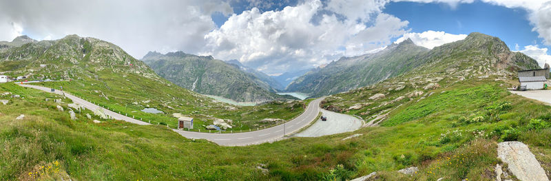 Panoramic shot of road amidst mountains against sky