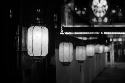 Illuminated lanterns hanging in building