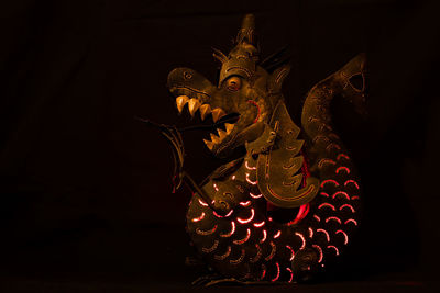Close-up of statue against black background
