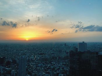 High angle view of buildings in city during sunset