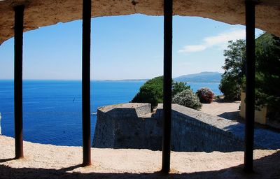 Scenic view of sea against sky seen through window