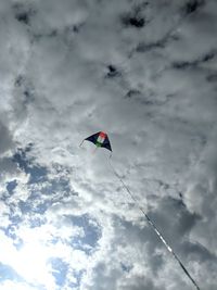 Low angle view of kite flying against sky